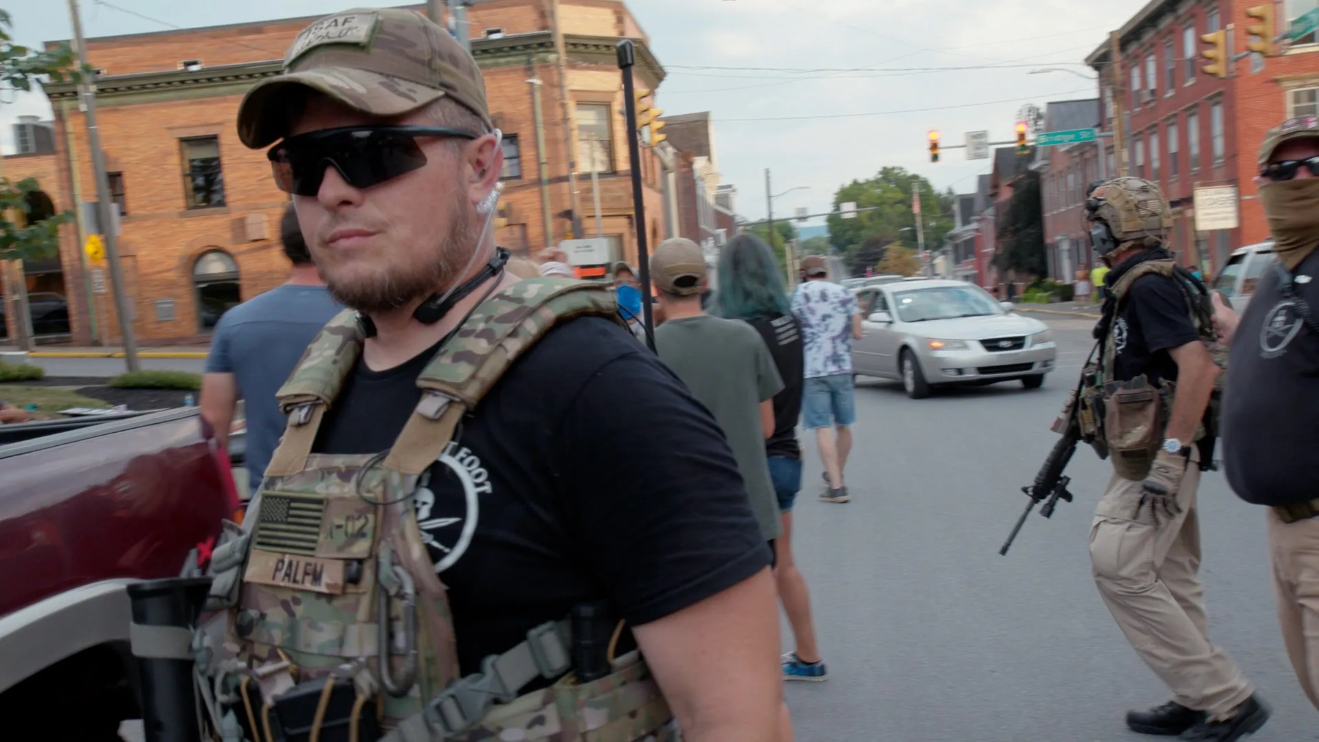 The militia leader walks through a small Pennsylvania town in tactical gear